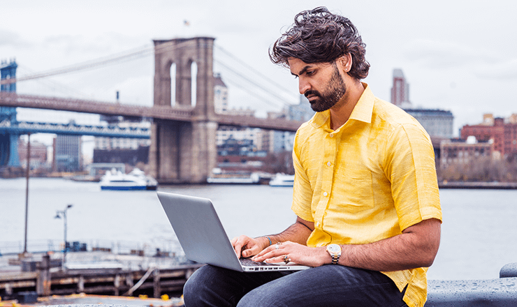 Male business owner on laptop in situ