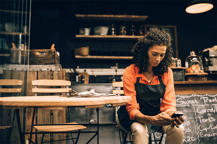 Woman sitting down looking at phone