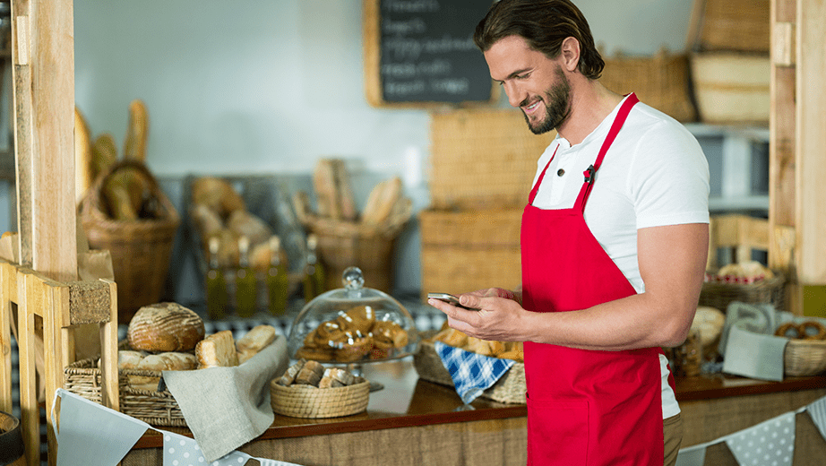 small-business-owner-smiling-on-smart-phone